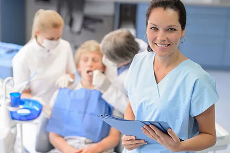 Dental assistants checking a patient